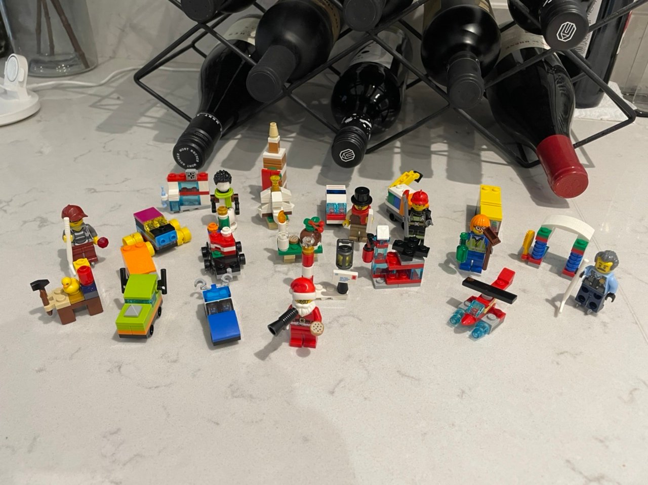 completed LEGO set with 24 different pieces, ranging from people to vehicles, with Santa in the middle