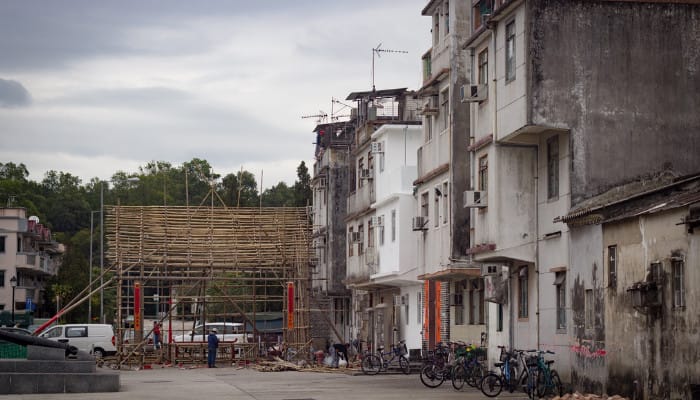 Bamboo poles being used to create a structure for an event.