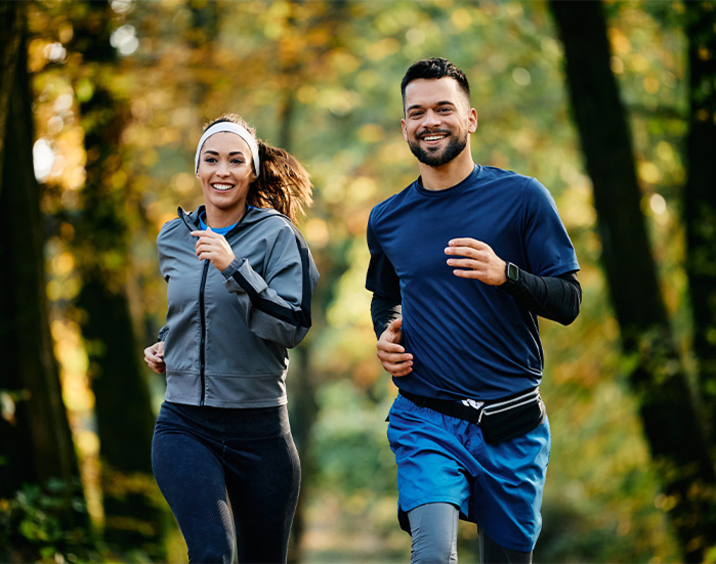 Woman in athletic wear smiling outdoors