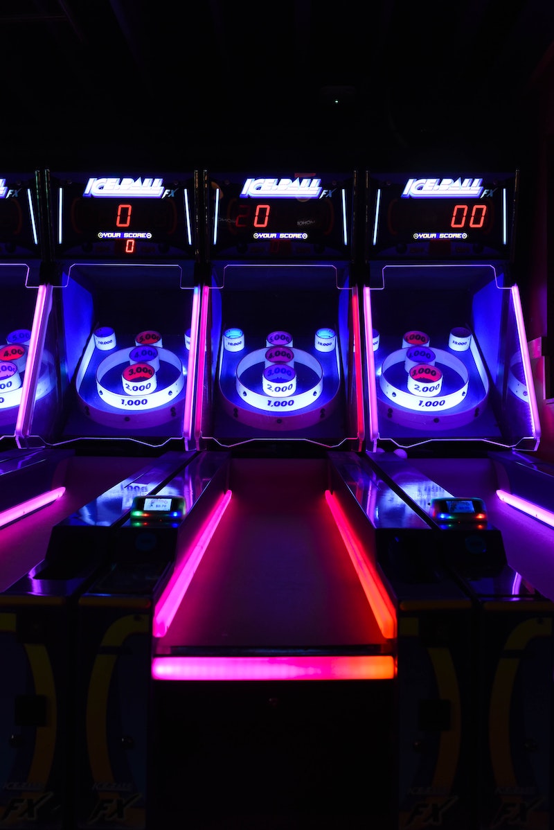 three neon-lit skee ball lanes. 