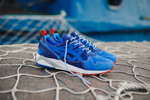 a pair of blue and red ASICS sneakers